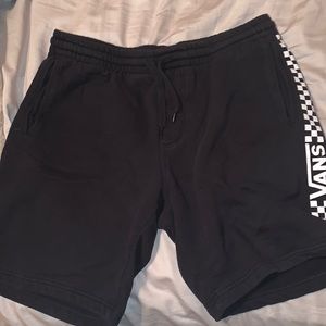 All black Vans shorts with checker board pattern